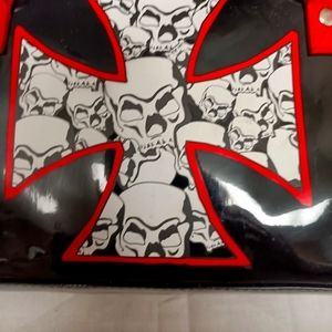 Black patent leather evening bag with skulls.